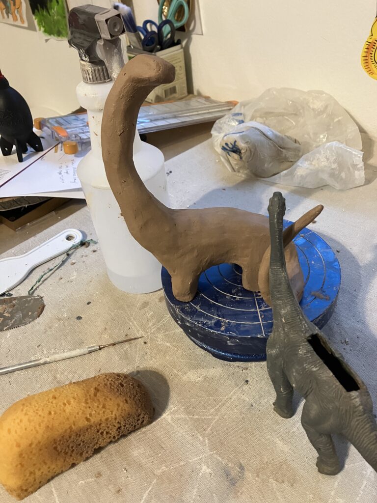 A brontosaur sculpture without any glaze or details.