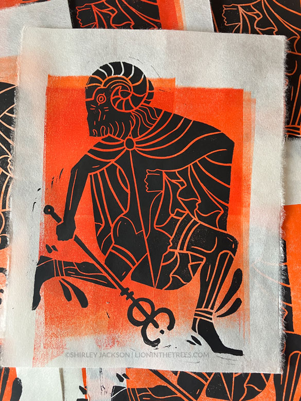 Linoblock print featuring a ram headed man against a orange block background