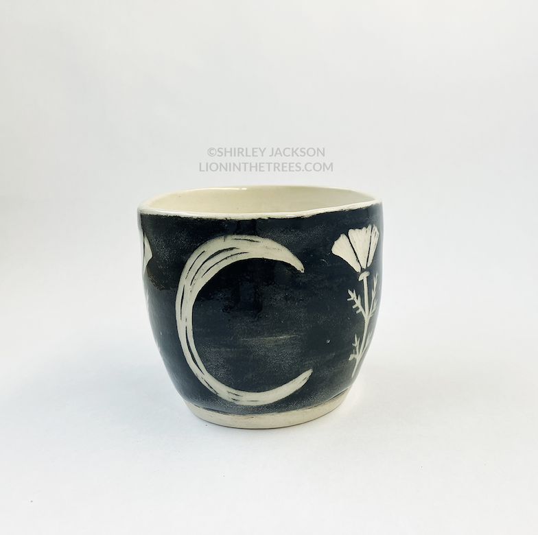 Photo of my black sgraffito planter that features a moon motif on the back