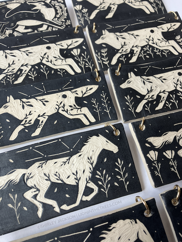 Close up of the wall slab pieces featuring my running horse and running wolf motif.