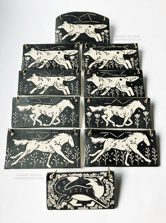 photo of all of my wall slab pieces in this latest pottery batch that features my running horse motif, running wolf motif, and one fox in thorns motif