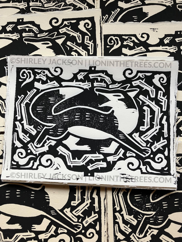 Linoblock print featuring a fox in motion surrounded by thorns. This print is all black.