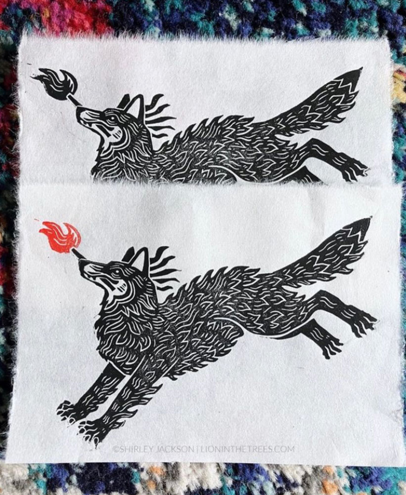 Two handmade prints featuring a coyote leaping with a stick of fire in it's mouth. The print above has a black flame and the print below has a red flame.