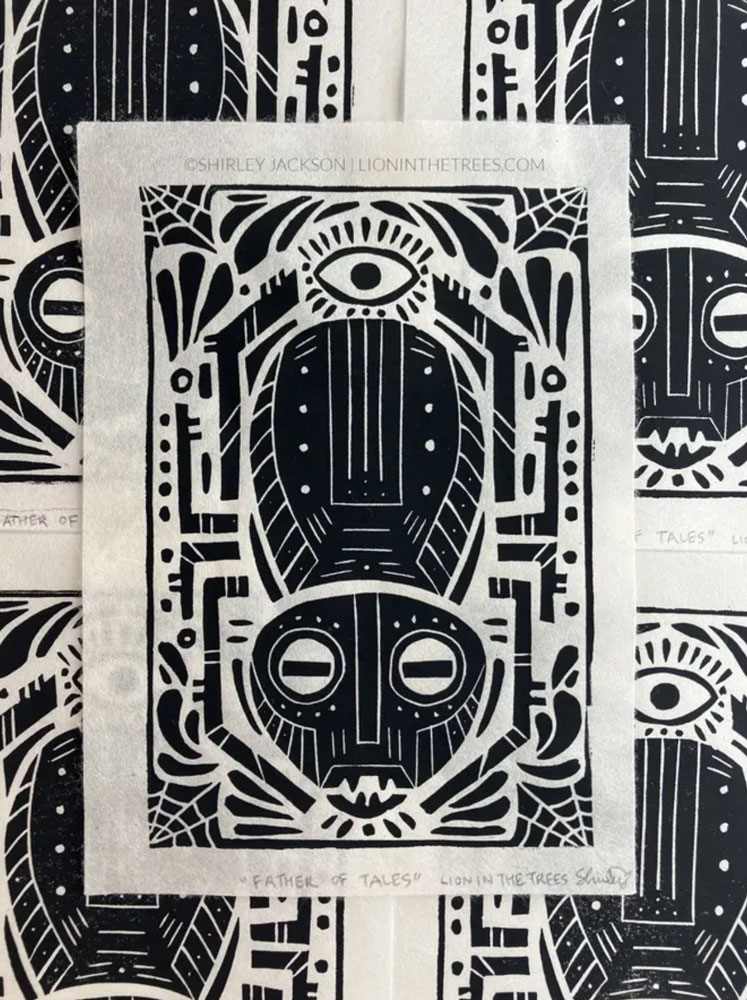 A linoblock print featuring a man spider motif with a variety of other design details such as webs, an eye, and various shapes. This print is all black.