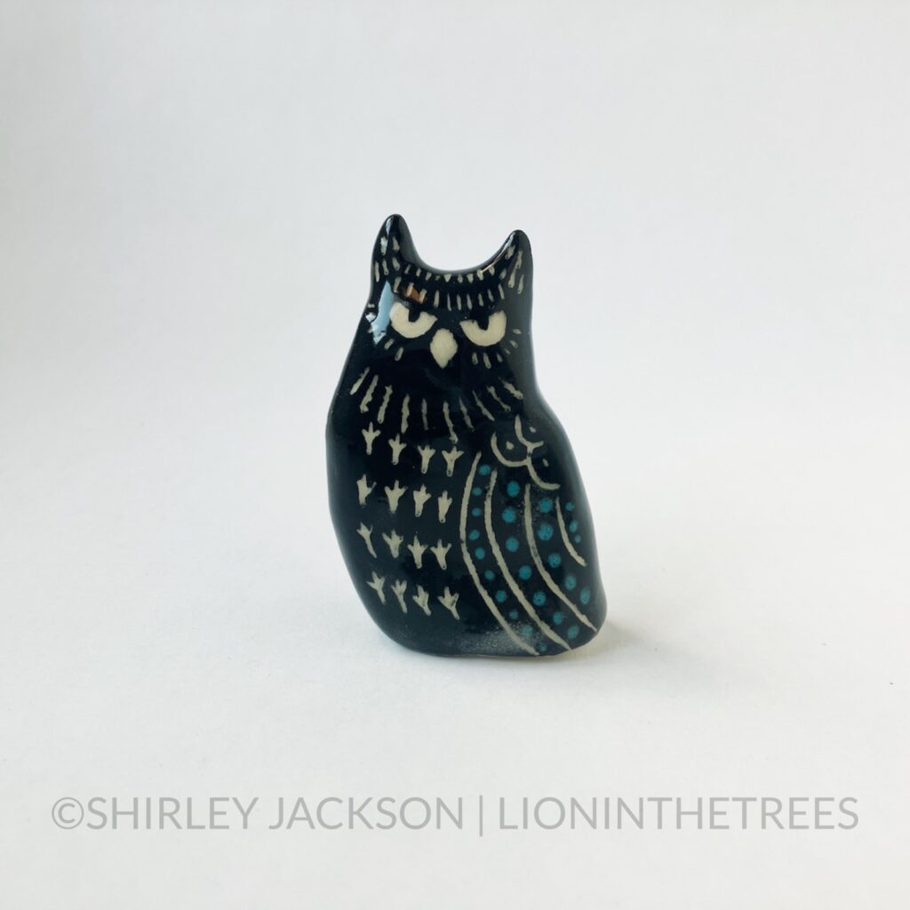 A ceramic sgraffito Horned Owl Totem with black and turquoise underglaze.