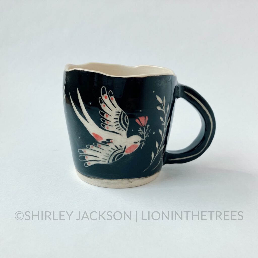 Front View - Ceramic sgraffito mug with black and red underglaze featuring my Barn Swallow motif.