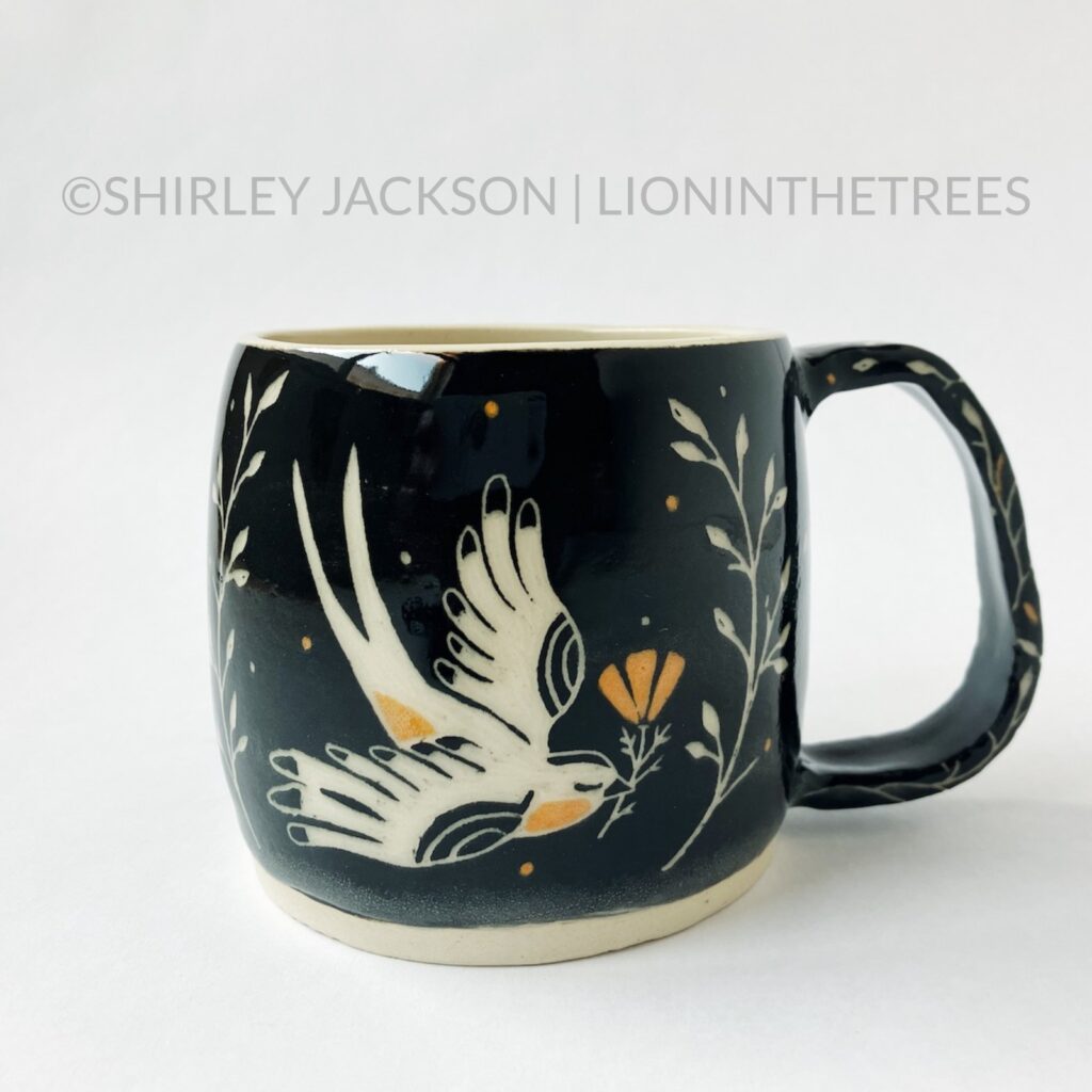 Front View - Ceramic sgraffito mug with black and orange underglaze featuring my Barn Swallow motif.