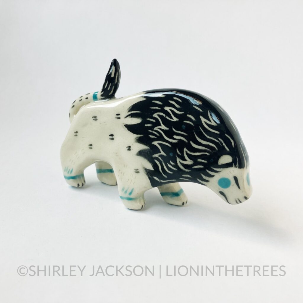 Right side view - Ceramic sgraffito lion totem with black and turquoise underglaze.