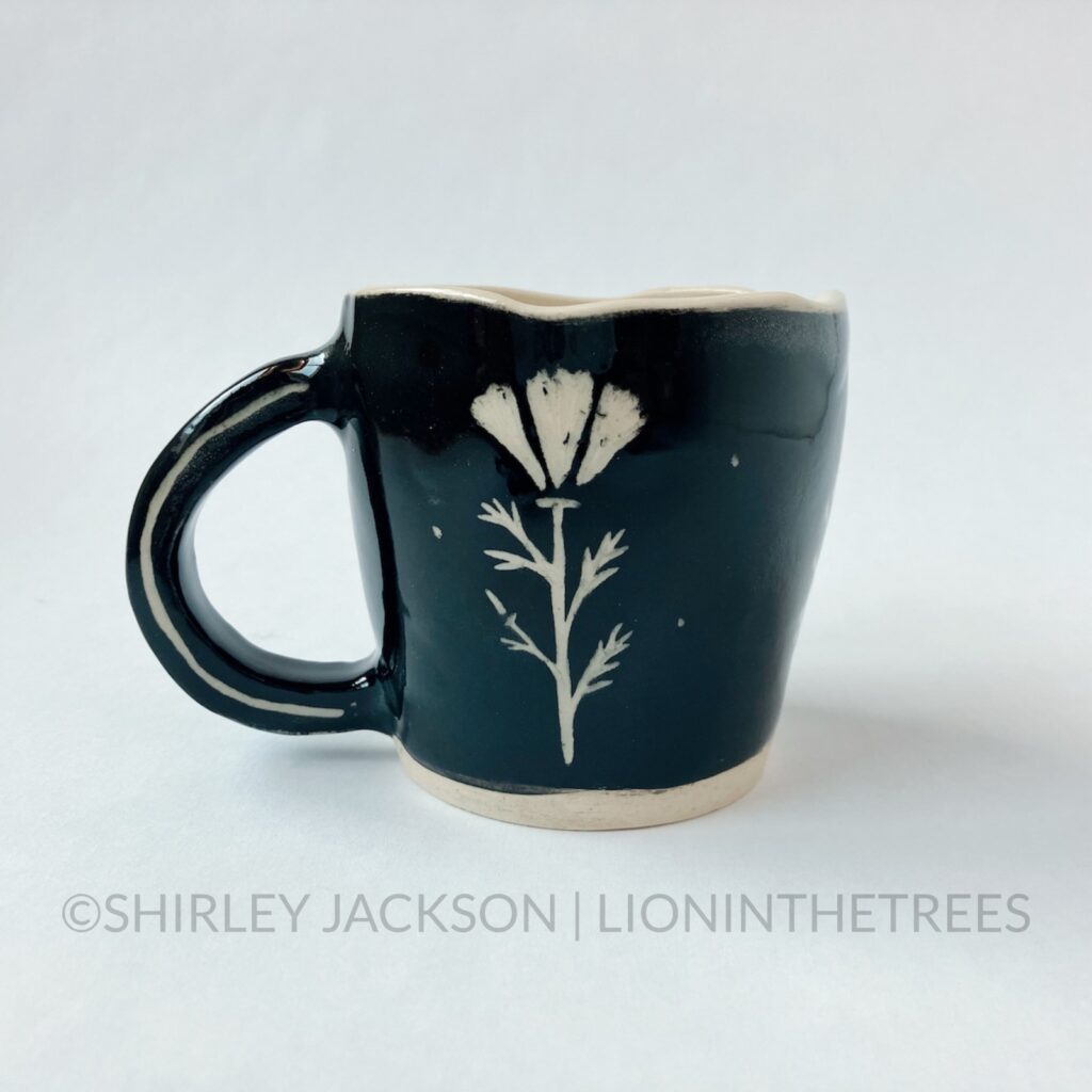 Back View - Ceramic sgraffito mug with black and red underglaze featuring my Barn Swallow motif. The back features a California Poppy.