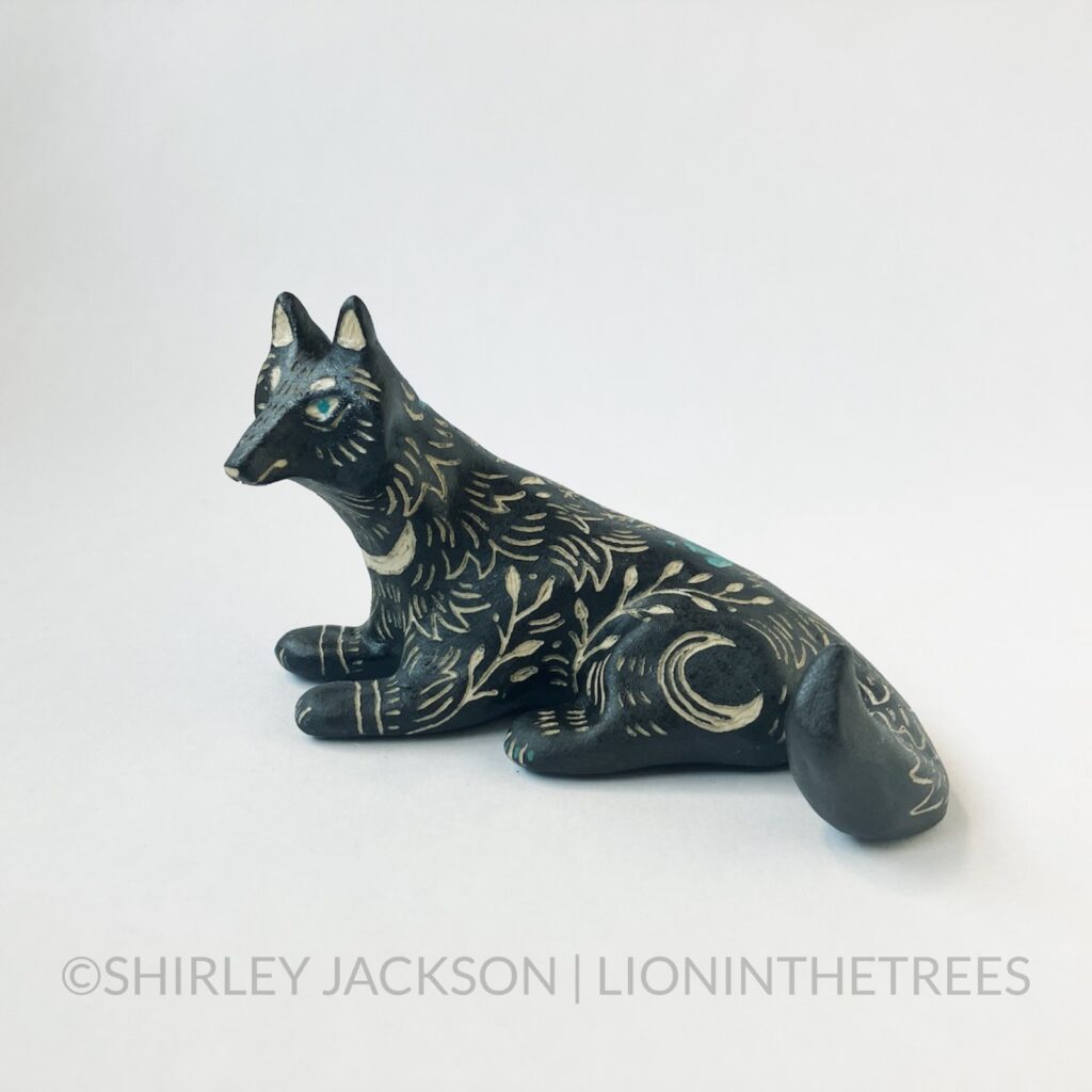 Left Side View - Ceramic sgraffito wolf totem done with black and turquoise underglaze. Features floral, fur, and crescent moon details all over it's body.