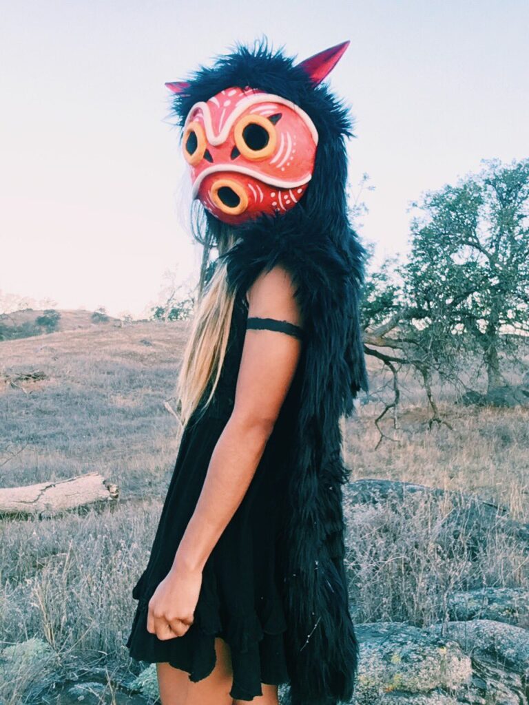 It's me, ya girl, in my DIY San outfit with the mask on. I chose to base my furs using a black wolf instead of a white wolf like the character in the movie. The San mask is similar in structure and design except I've added additional African inspired markings. Instead of a white tunic and blue dress I've got a black dress on.
