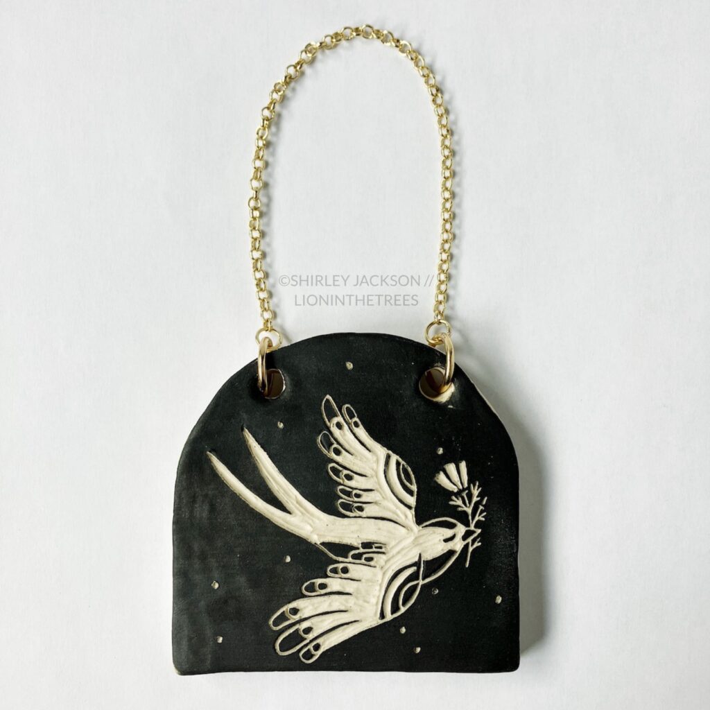 Ceramic black sgraffito wall slab featuring my Barn Swallow motif