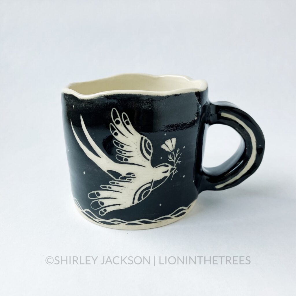 Ceramic black sgraffito mug with my swallow motif and a California Poppy motif on the back.