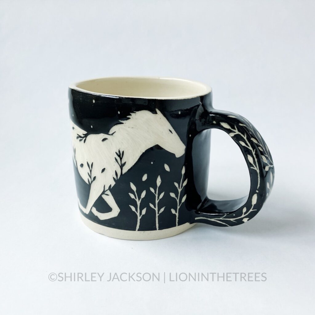 Ceramic black sgraffito mug featuring my Running Horse motif.