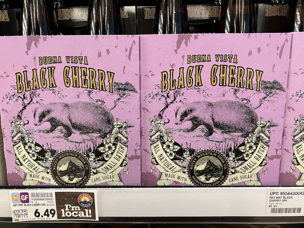 Rocky Mountain Soda Co.'s Buena Vista Black Cherry pop that shows a vintage styled illustration of an American Badger done in black against a purple background.