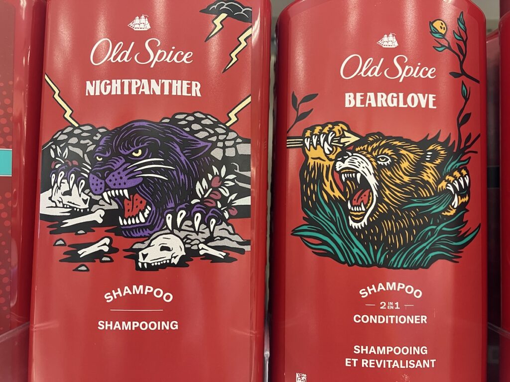 Photo of two Old Spice hair care products. The stylistic design for these animal icons on the products resembles that of a woodblock relief print. One is NIGHTPANTHER which features a purple and black with it's paws gripping mounds of skulls and lightning in the background. The other is BEARGLOVE which features a orange and black bear angrily roaring is it grabs arrows in one hand and rips blades of grass in the other.