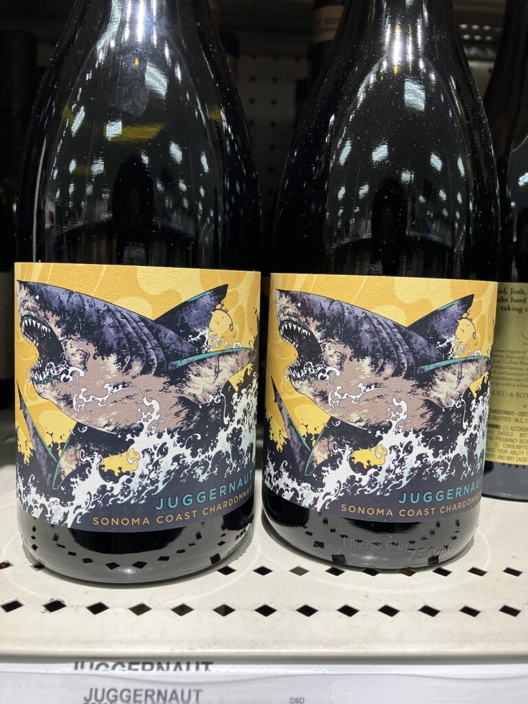 Bottle of Juggernaut brand chardonnay that features an illustrated shark leaping out of the water.
