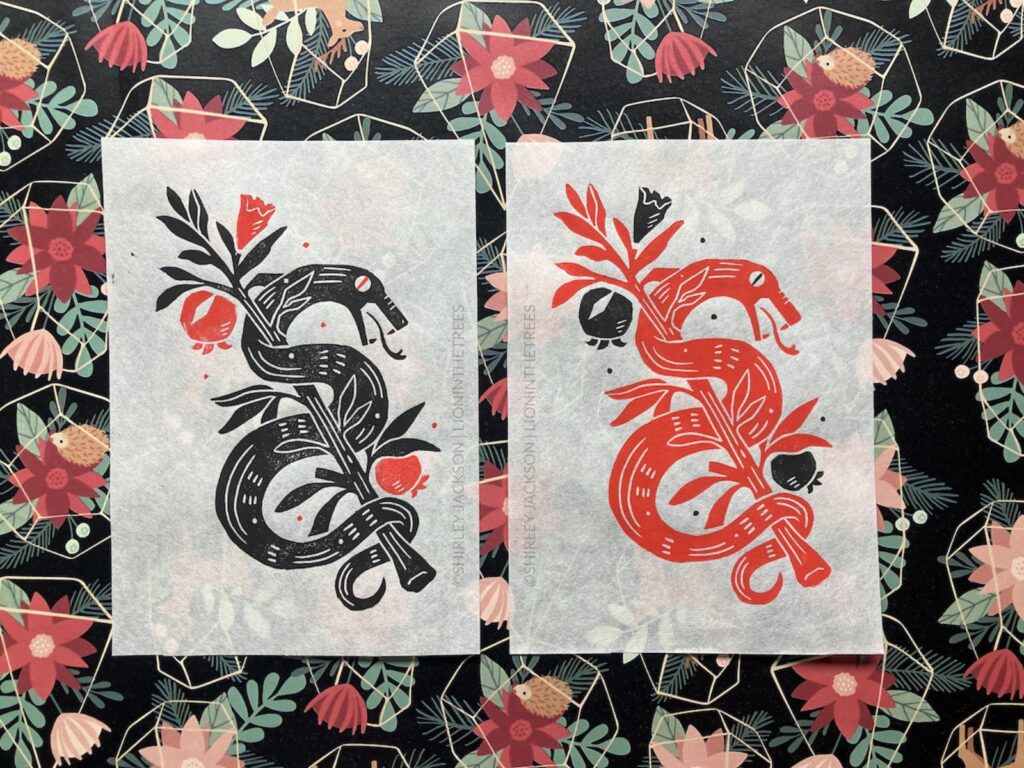 A photo showing the black and red colour variant of this snake print side-by-side