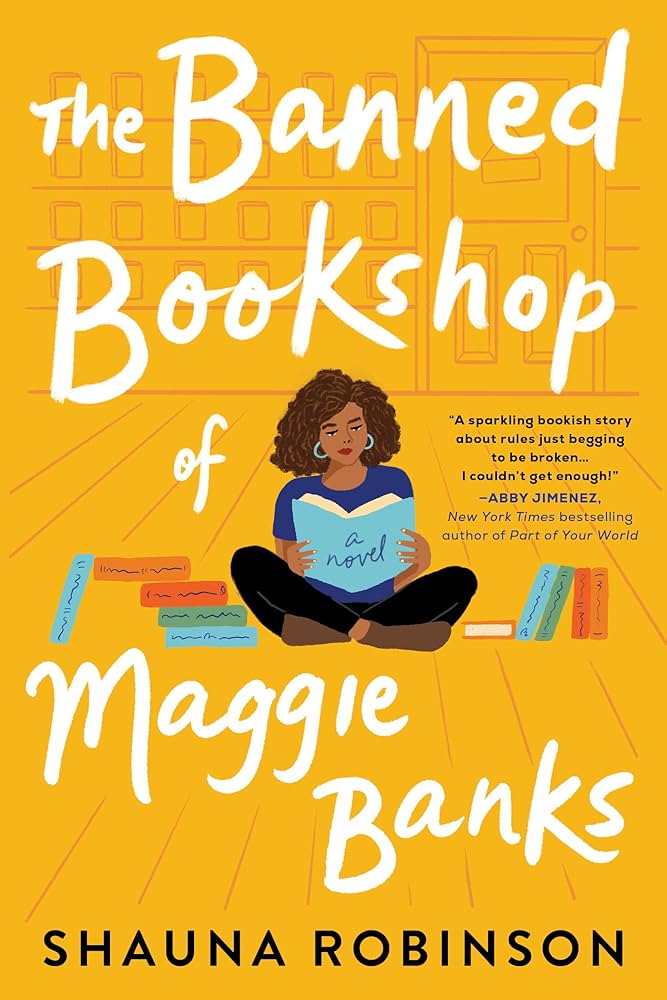 Cover for The Banned Bookshop of Maggie Banks by Shauna Robinson. It's a yellow background with a sketch of what appears to be a bookstore. There is a Black woman sitting on the floor reading a book with piles of books on either side of her body.