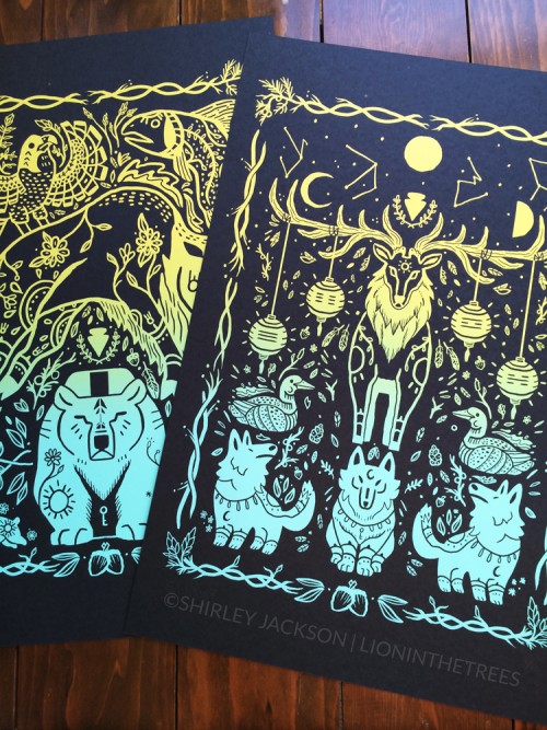Photo of my "Balance" and "Harmony" screen prints. These prints feature wildlife found in Yellowstone National Park such as wolves, elk, bears, bison, and more. The prints were done on a black paper and used a yellow to turquoise split fountain roll technique.