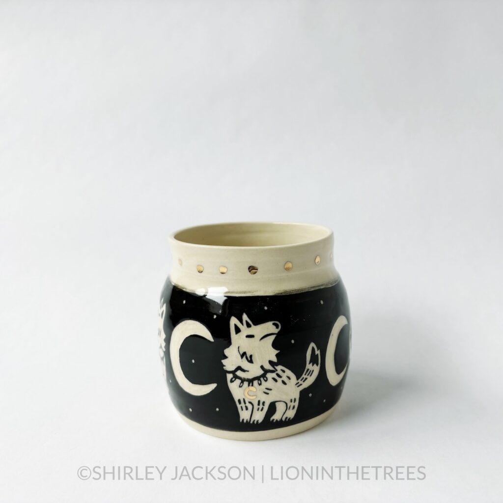 Ceramic black sgraffito vase featuring my Keeper Wolves motif.