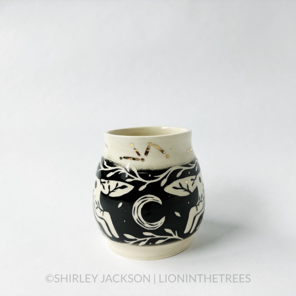 Ceramic black sgraffito vase featuring my Running Wolf motif, crescent moons, and gold luster constellation details.