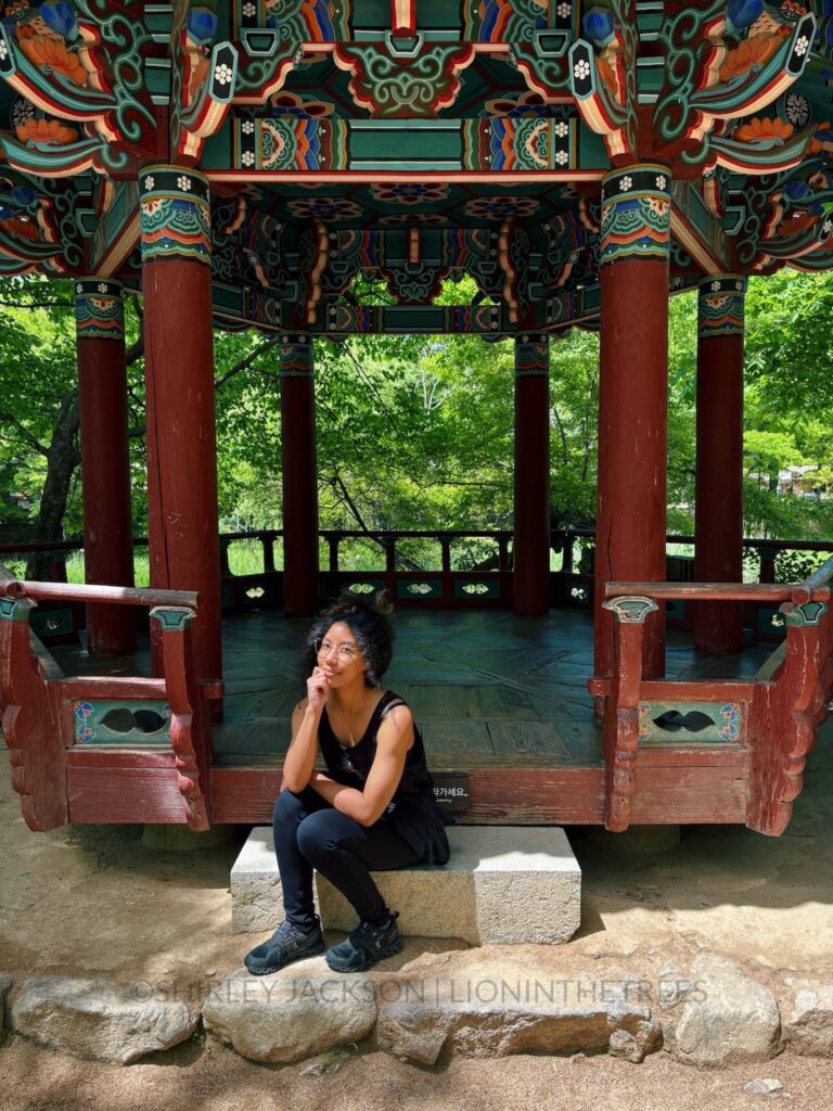 Me sitting posed on the steps of one of the temple structures