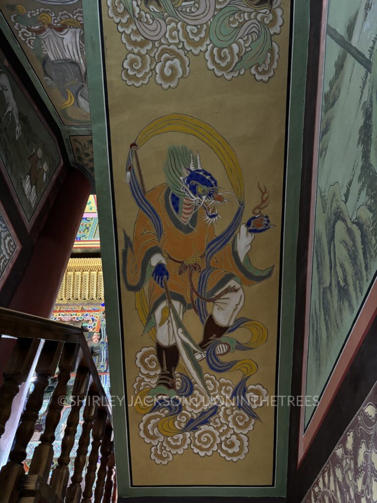 Close up photo of a mural found in the Buddha temple featuring an anthro Dragon