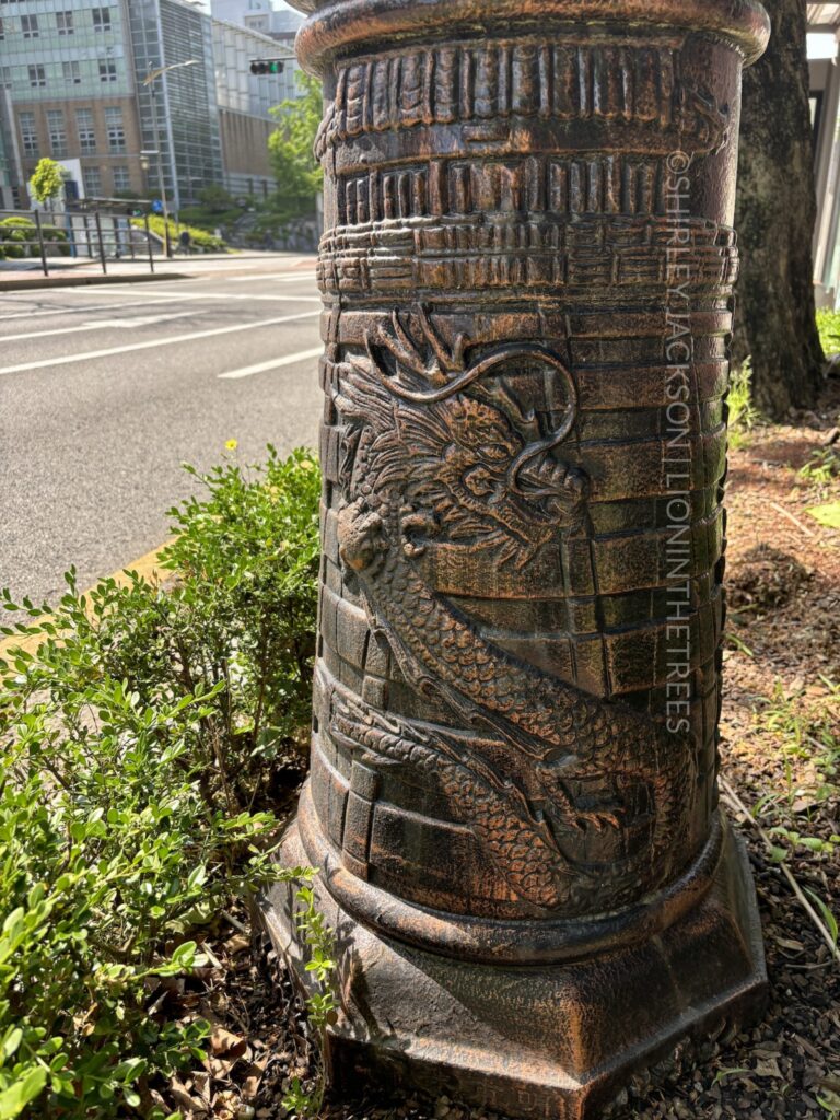 Photo of a gorgeous dragon design on the bottom of a lamp post