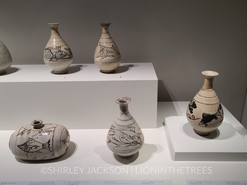 Photo of a variety of vases that feature a fish motif