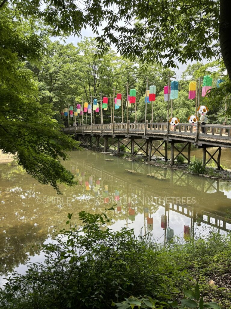 Photo of a bridge with rectangular coloured paper lanterns