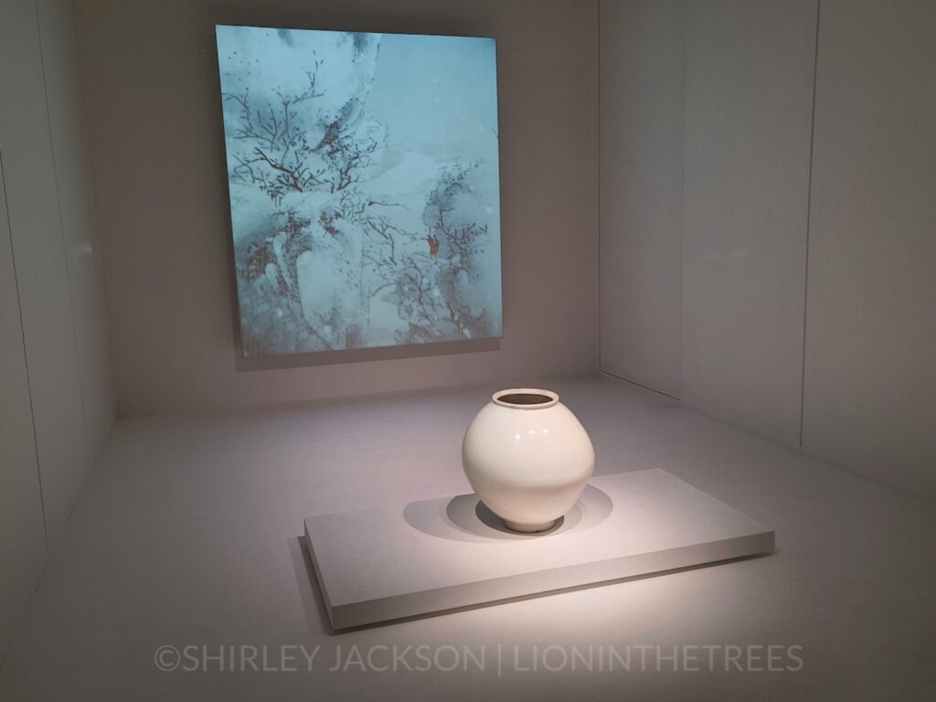 Another moon jar but this one is more symmetrical and placed in an empty white room with a projection of a winter landscape behind it