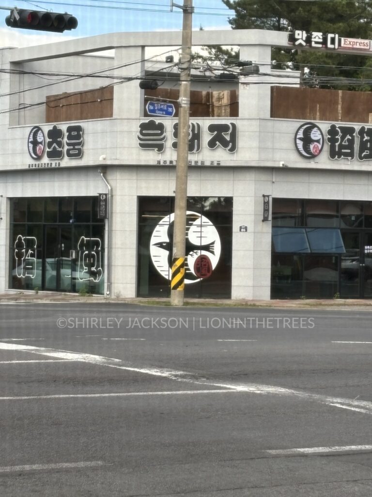 Photo of a stylised black bird logo on a building