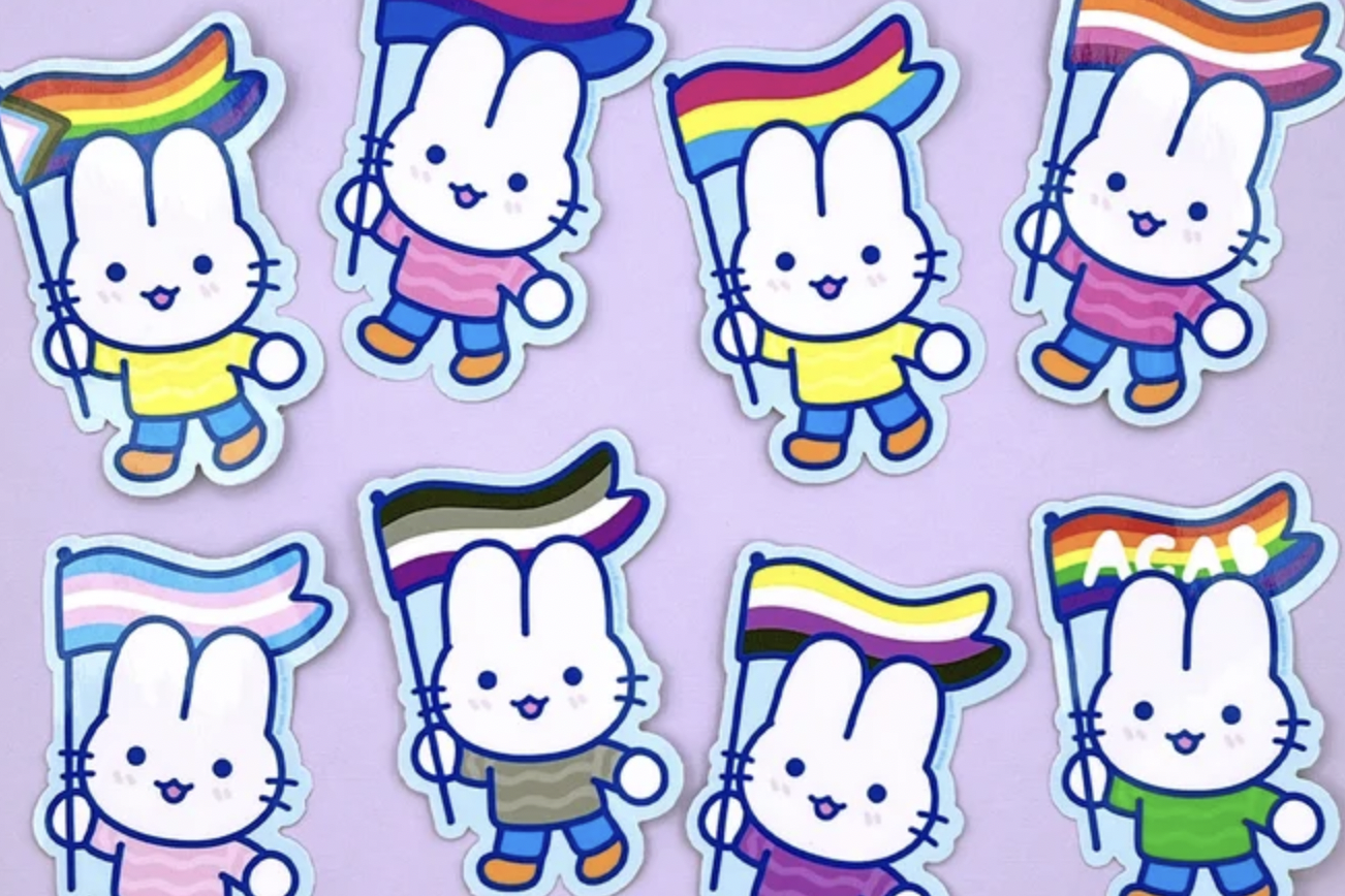 photo of a series of stickers designed by Bree Lundberg that features very adorable rabbits holding all of the different LGBTQ+ related flags.