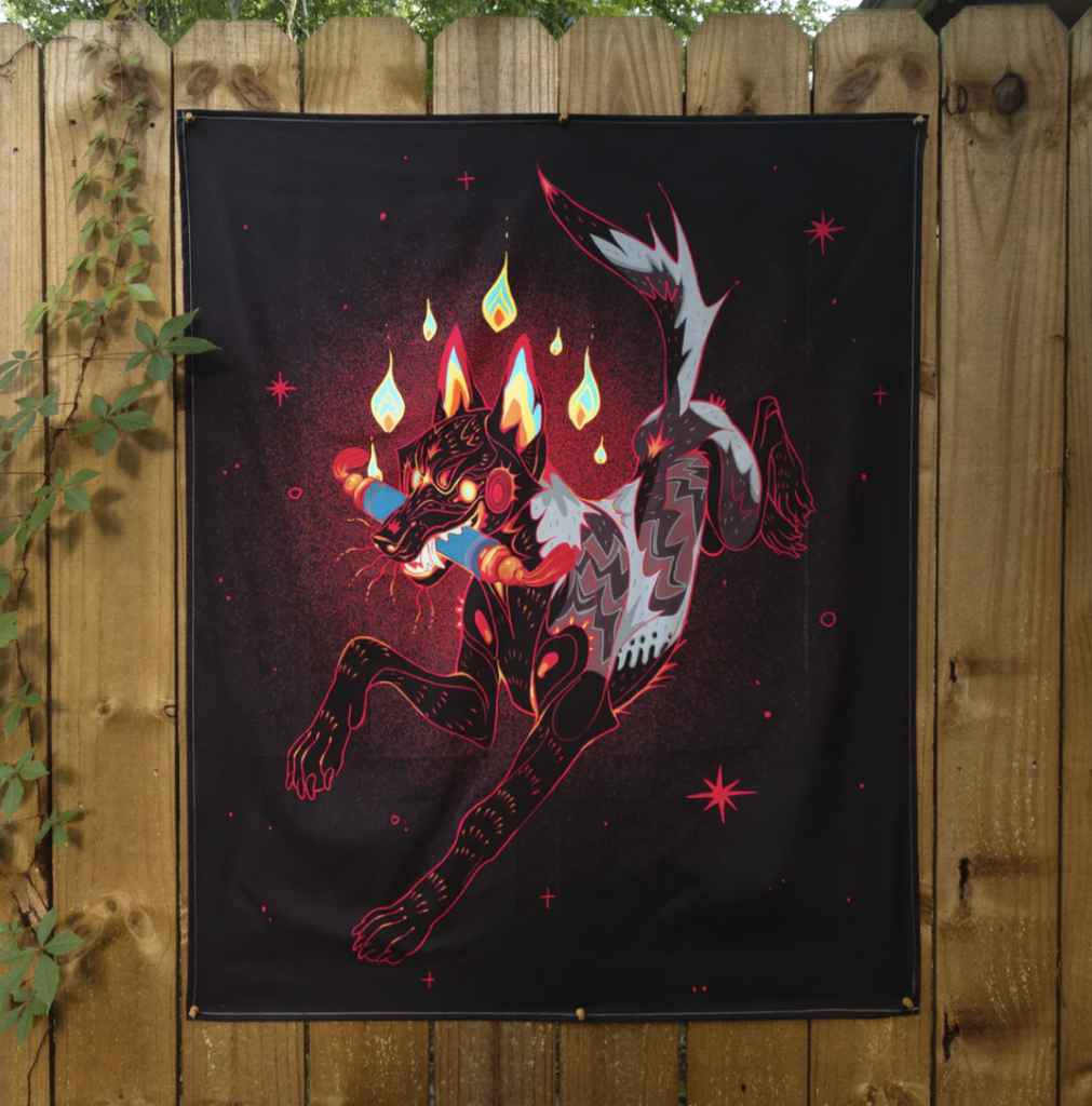 A black tapestry featuring a black and fire-y canine that’s carrying a cylindrical object in it’s mouth. Made by Aspen Eyes.