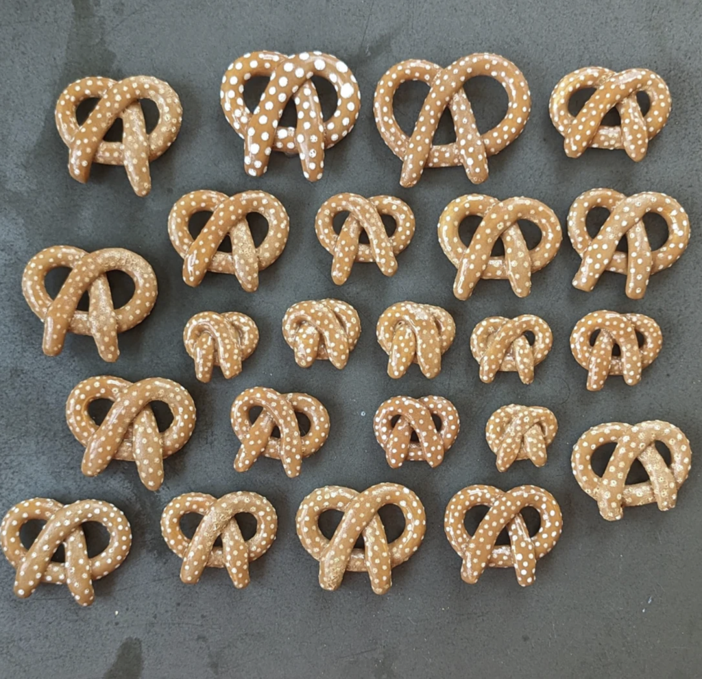 A series of ceramic handmade magnets done to look like pretzels Made by chicagoqueercreations