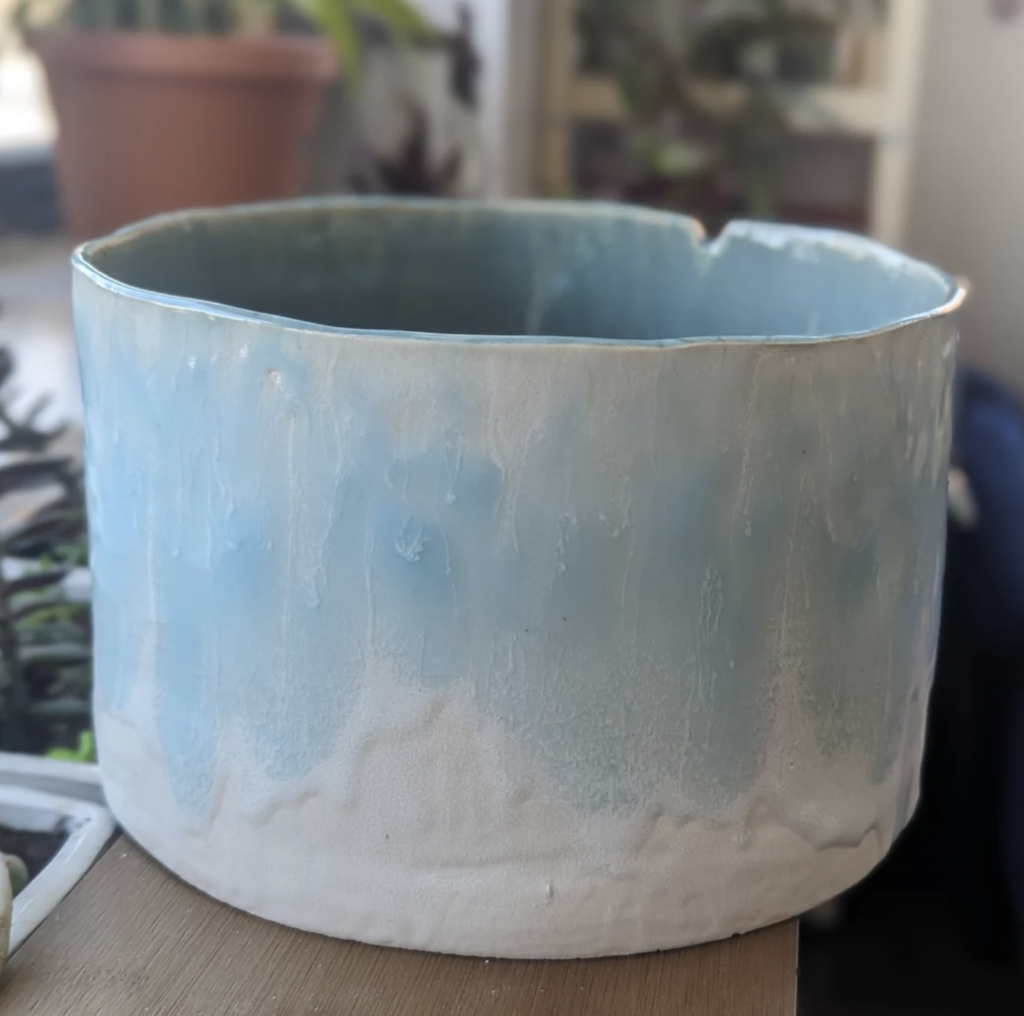 A large bowl shaped object done with a beautiful cloud blue and white drip glaze. Made by chicagoqueercreations