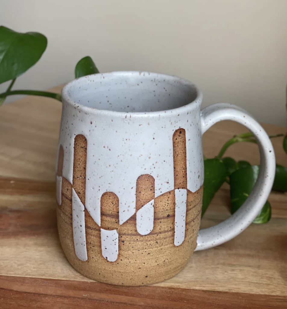 Matte grey mug with brown speckled clay. Design shows matte grey on top predominantly and brown speckled clay on the bottom in resist. Made by Nissa Arts