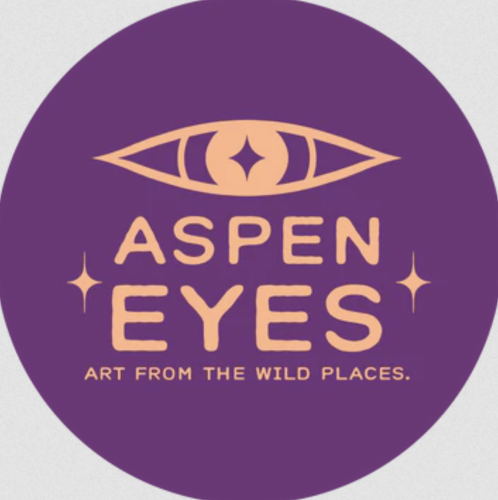 Circular purple logo that says "Aspen Eyes. Art from the wild places." with an eye over the top of the typography.