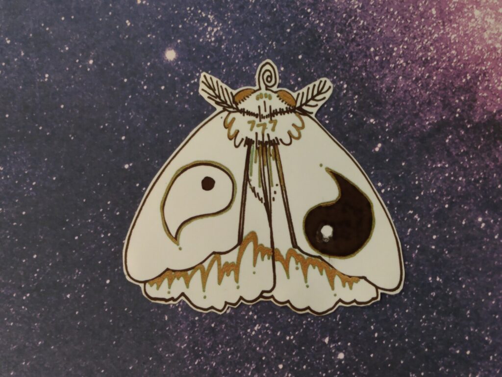 A yin yang moth sticker Made by Averted Visionary.