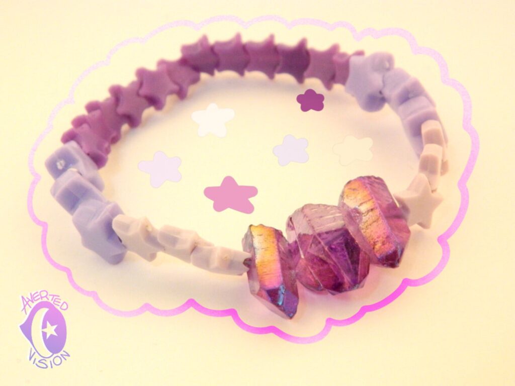 A purple, lavender ombre bracelet that was constructed with star beads and amethyst. Made by Averted Visionary.