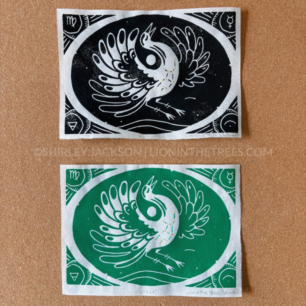 Photo of two relief prints featuring a Sandhill Crane with Virgo astrological symbols and associations within the design. One is done with black ink and the other is done in green to symbolise Virgo's connection to the element of earth.