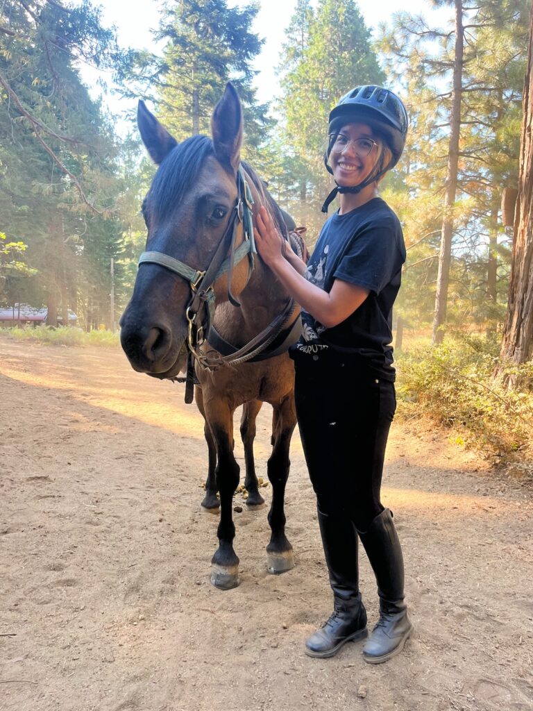 Photo of me and Dusty, the dun Mustang mare cheesing it up for the camera.