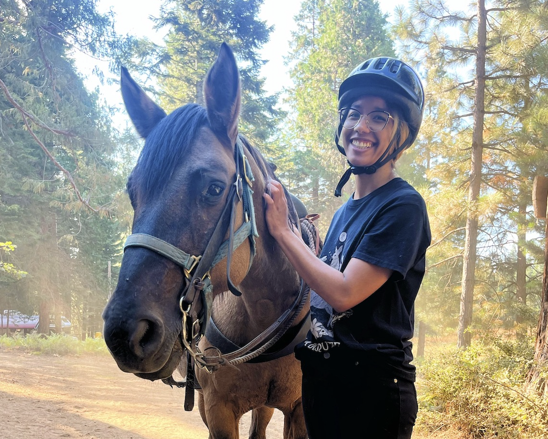 Photo of me and Dusty, the dun Mustang mare cheesing it up for the camera.