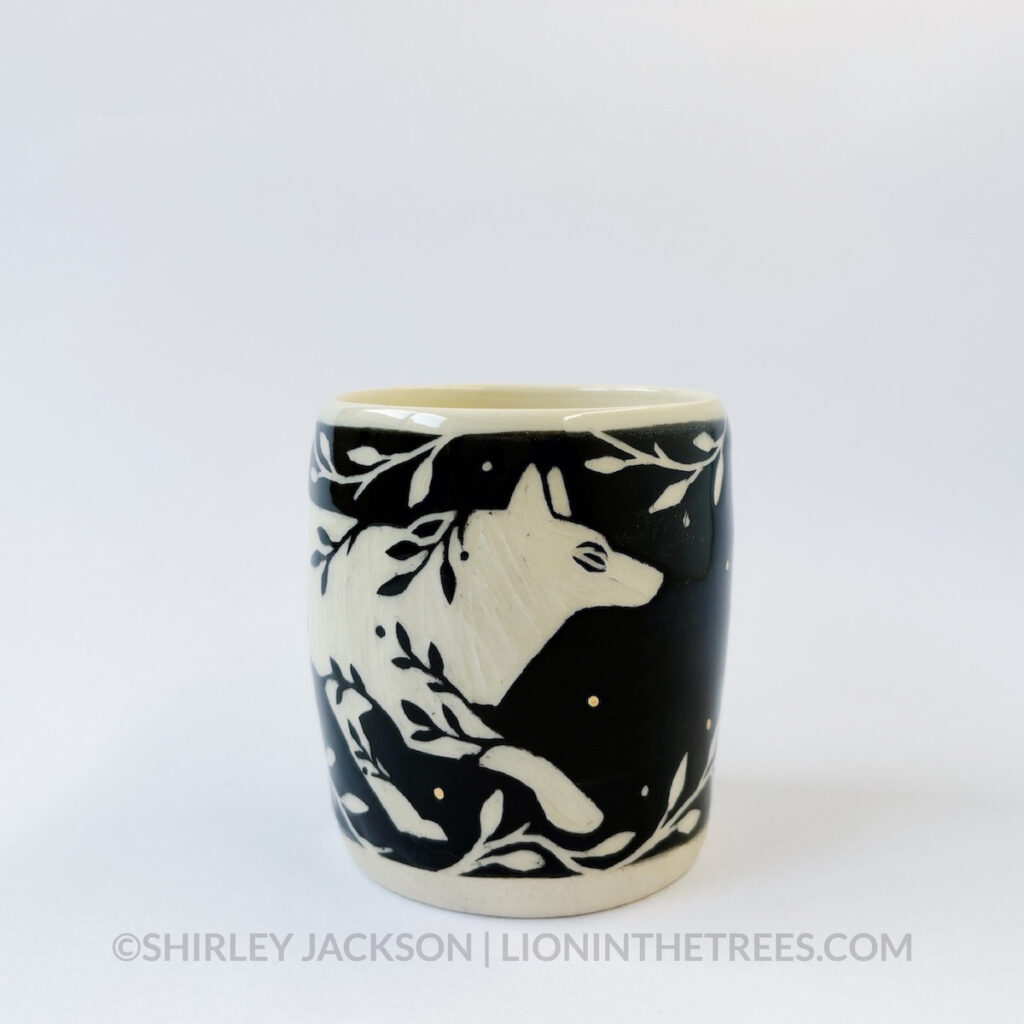 Medium vessel done with black underglaze and gold overglaze details featuring my Running Wolf motif.