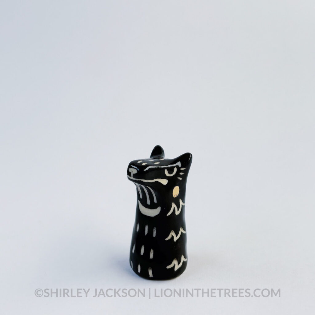 Small black sgraffito wolf totem.