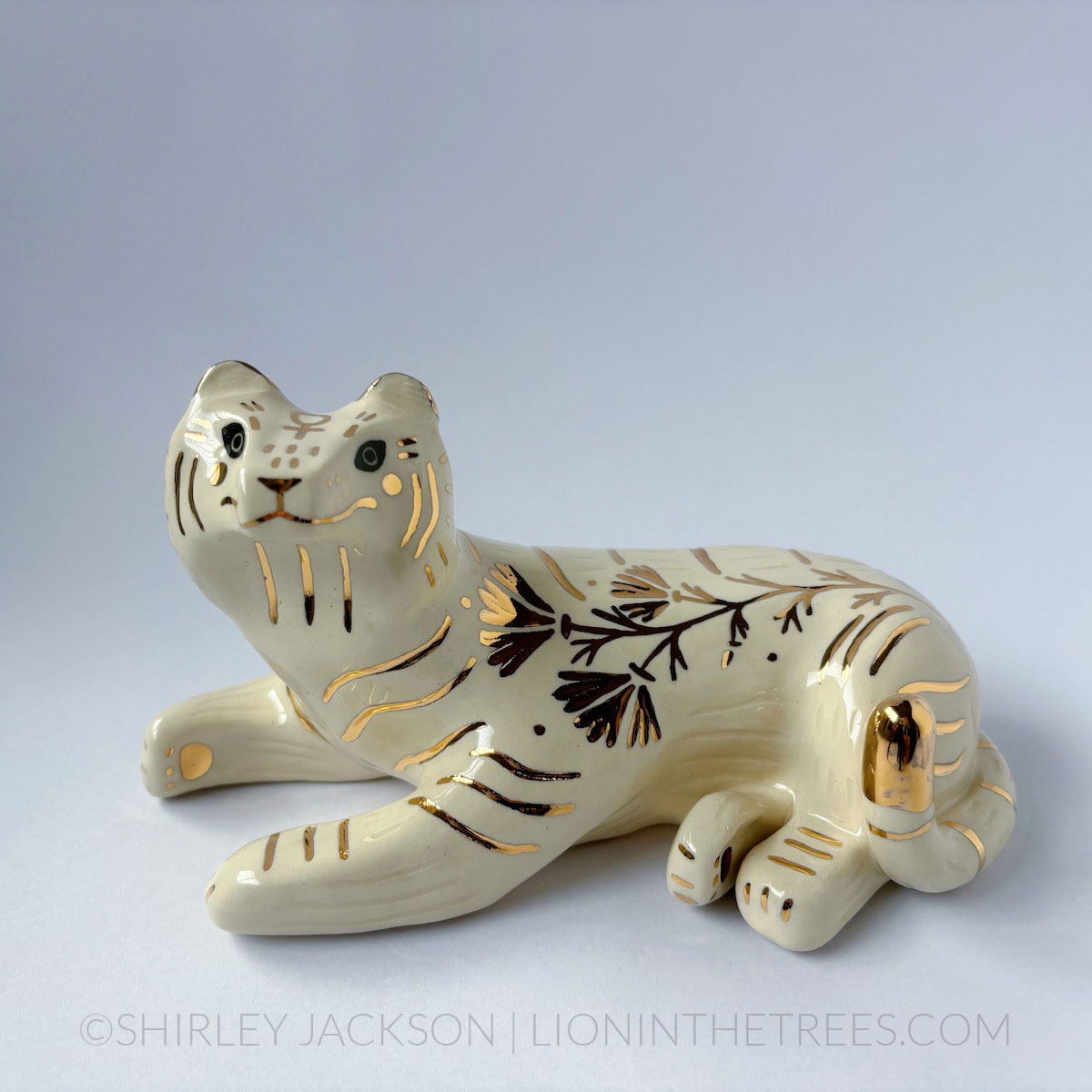 Sgraffito white/gold tiger totem with California Poppy motifs on it's side, and the sign of Venus on it's forehead.