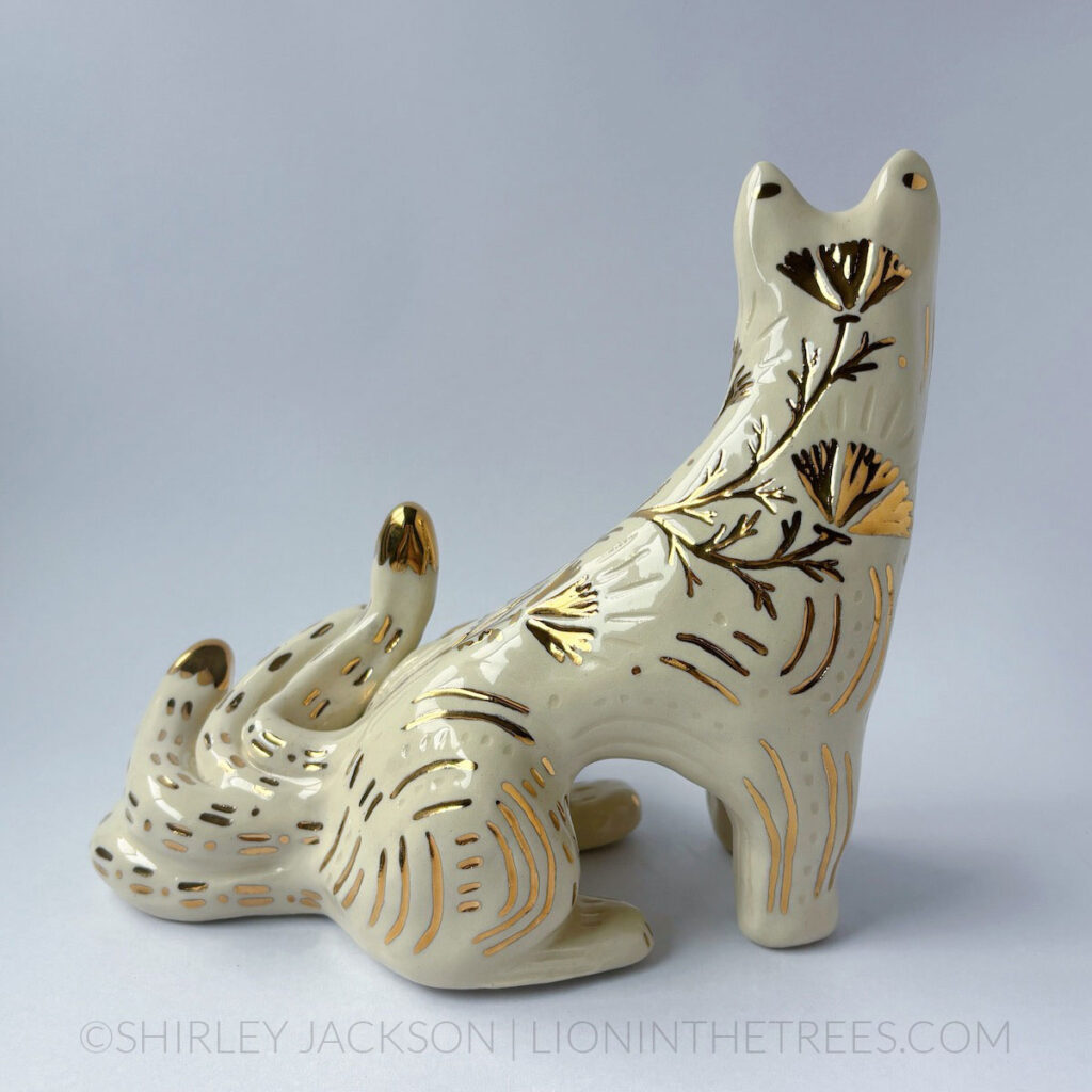 White sgraffito Kumiho with gold overglaze details all over it's body.