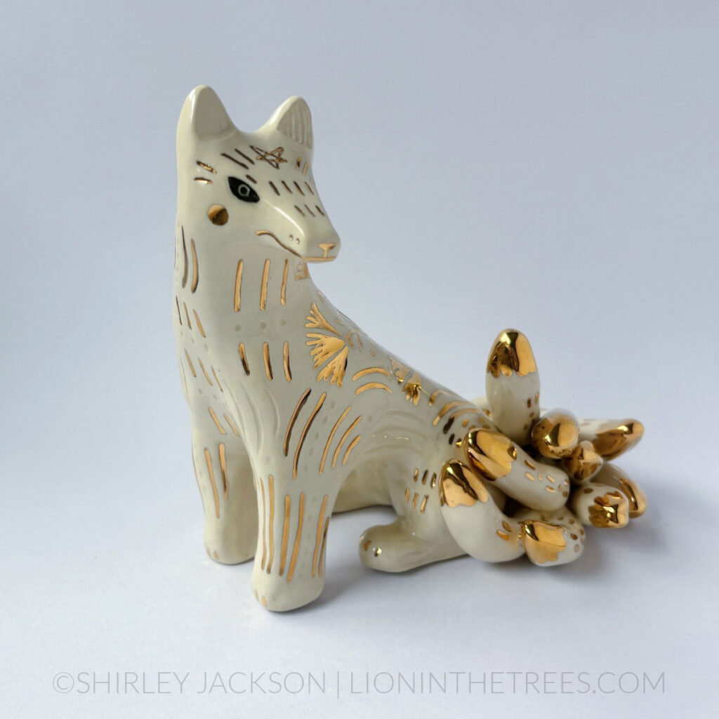 White sgraffito Kumiho with gold overglaze details all over it's body.