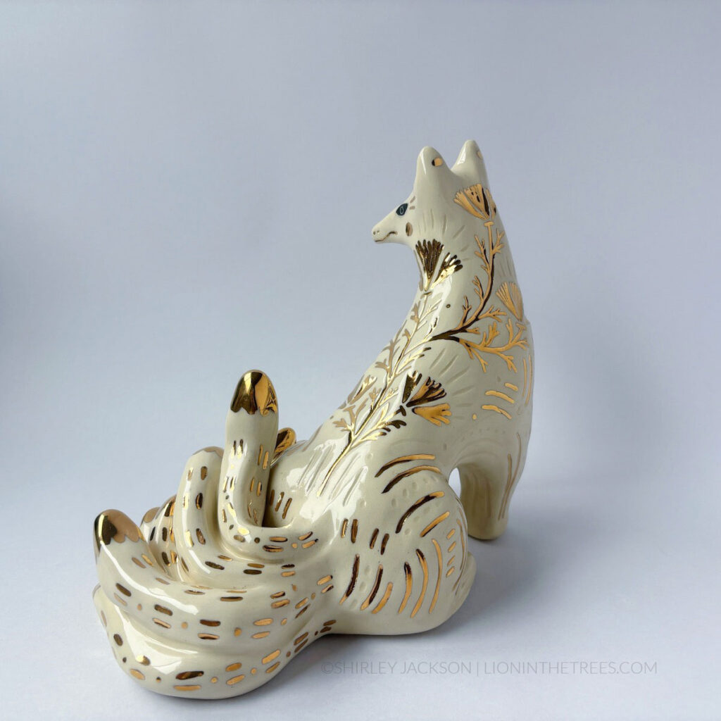 White sgraffito Kumiho with gold overglaze details all over it's body.